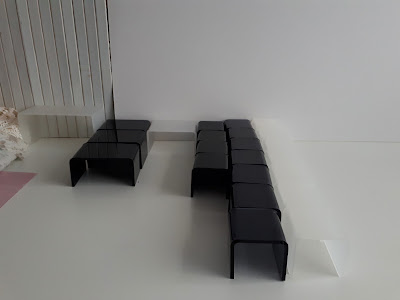 Lines of one-twelfth scale modern miniature perspex coffee and side tables.