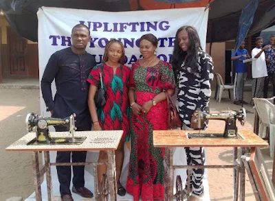 convener, Uplifting Youngsters Foundation (UYF), Ms Chioma Ejere with some beneficiaries at Ajegunle presentation @ITREALMS