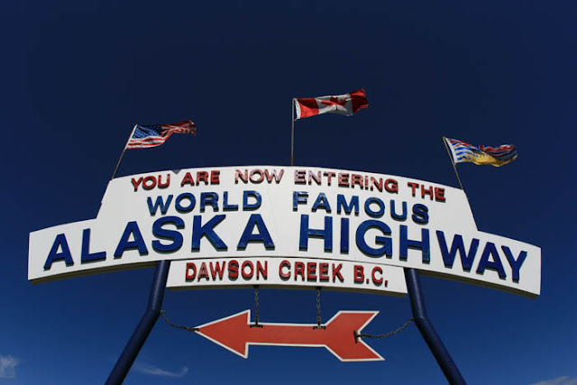 The 'You Are Now Entering The World Famous Alaska Highway' sign in Dawson Creek, British Columbia.