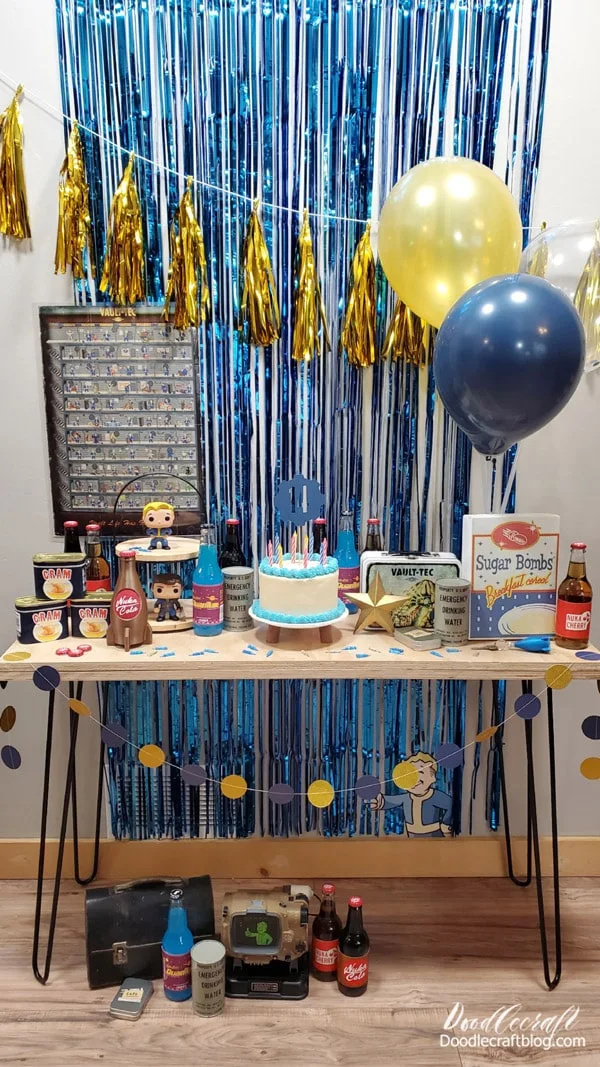 I used balloon sticks from the dollar store and stuck them inside a vase.   I used command hooks to hang the tassel bunting.   The fringe backdrop has adhesive on it and that was enough to stick it to the wall without damaging it but stay stuck all day.