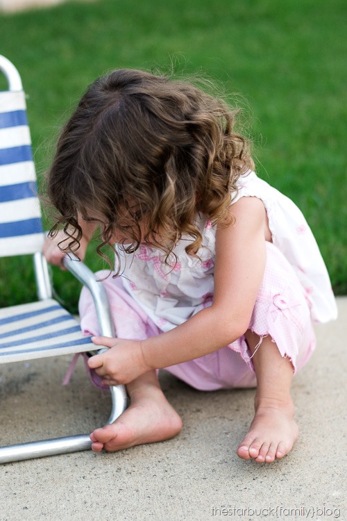 Abby playing with lawn chair and in carport blog-11