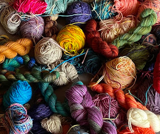 a pile of colourful yarn balls