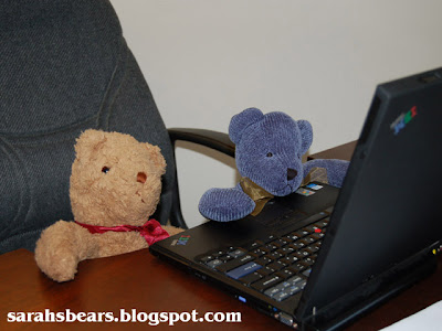 Teddy bears working on computer