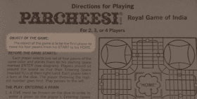 A photo of the rules for Parcheesi printed on the inside of the box top. The object of the game is highlighted: it reads 'The object of the game is to be the first player to move his four pawns from his START to his HOME.'