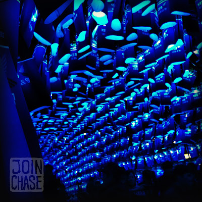 People walking under hundreds of blue lanterns in Seoul, South Korea.