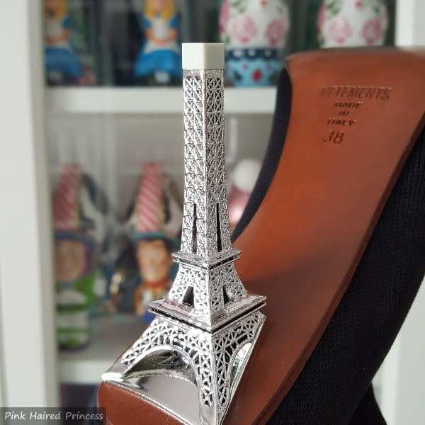 close up of silver Eiffel Tower shaped heel on boot