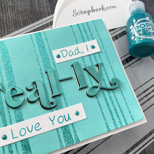 Father's Day pun card created with: Scrapbook.com pops of color teal twinkle, festive alpha die set, mixed stripes stencil, craft scraper; Tim Holtz distress oxide salvaged patina and peacock feathers, metallic kraft stock