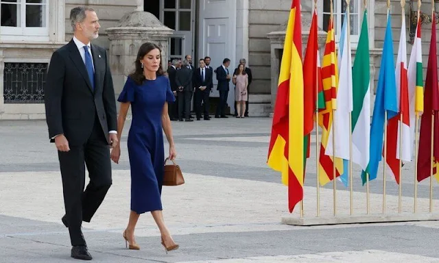 Queen Letizia wore a navy blue flutter sleeve midi dress by Carolina Herrera. Carolina Herrera pumps and Doma insignia bag