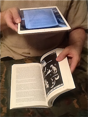 Taking a photo of a page, with the poster for NIGHTBIRDS  on the opposite page