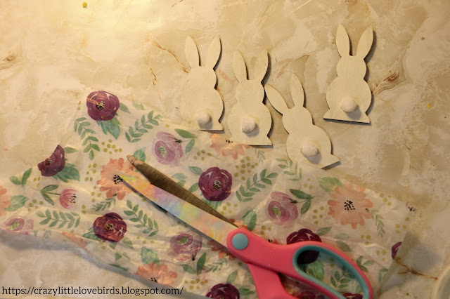 Tissue paper, scissors and wooden bunnies