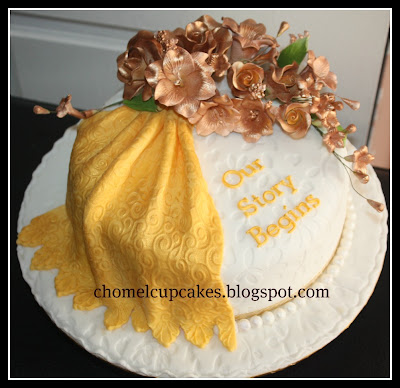 A fondant wedding cake in gold and white as a hantaran to her husband
