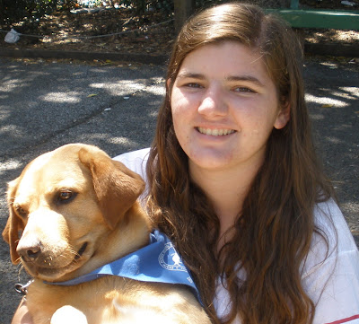 Kayla Hufford with yellow Lab puppy