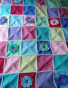 A beautiful colourful crochet blanket with a lovely waterlily design - click through for inspiration for a stunning cosy flower crochet blanket.