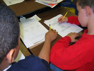 2 students looking over a paper