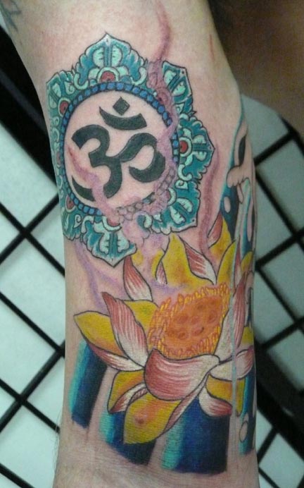 This tattoo is tapping into the energy of the Lotus Flower and Om Bright 