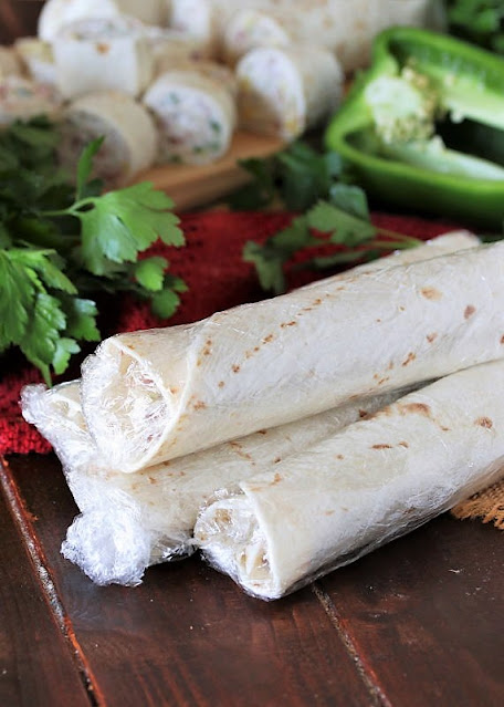 Pineapple-Ham Tortilla Roll-Ups Wrapped in Plastic Wrap Image