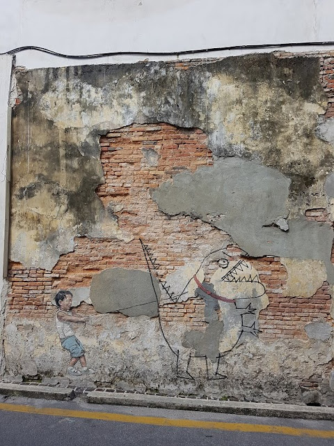 penang street art mural lebuh ah quee little boy with pet dinosaur