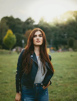 A Fashionable Women Wearing Black Leather Jacket and Blue Jeans