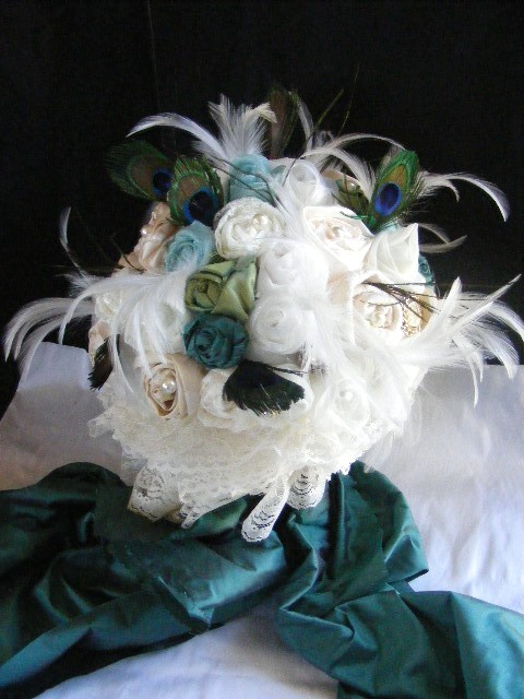 This gorgeous bridal bouquet has been accented with peacock feathers