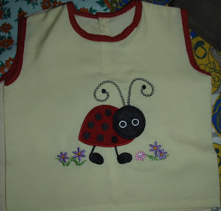 THis baby frock is made using the ladybug applique embrpidery pattern on the computerised machine