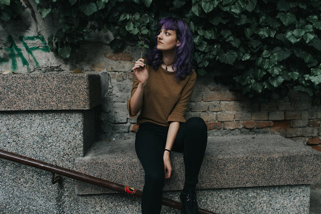 amethyst curly hair and brick wall with ivy