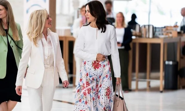 Crown Princess Mary wore a sunray pleated scarf print skirt by Paul and Joe, and white silk blouse by Elise Gug