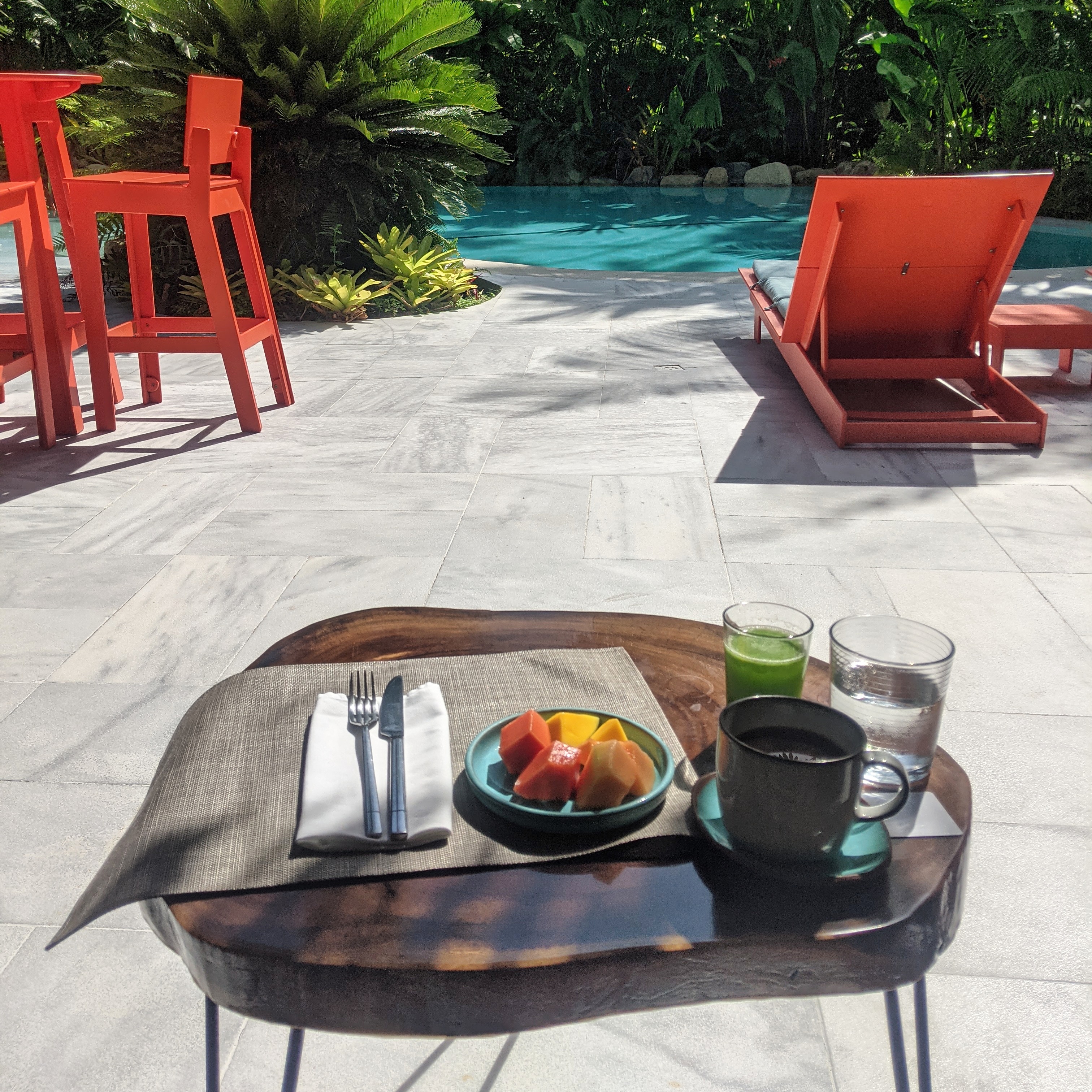 table laid with fruit and juice at papaya restaurant in agues Claras hotel