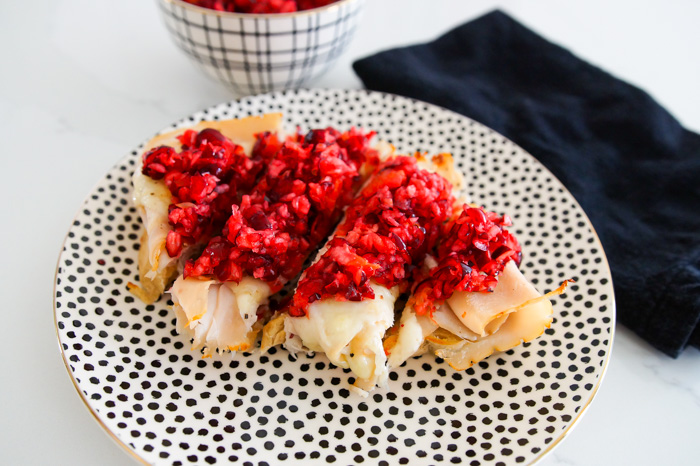 Turkey and Swiss Tartine with Cranberry Relish on black and white polka dot plate