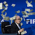 [VIDEO]: LOLS...Comedian Throws Bank Notes At FIFA President During Press Conference