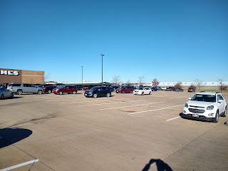 big-box store parking lot, few cars