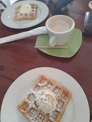 " Waffles with whipped cream and cappuccino from restaurant "De verdieping" in Paramaribo"