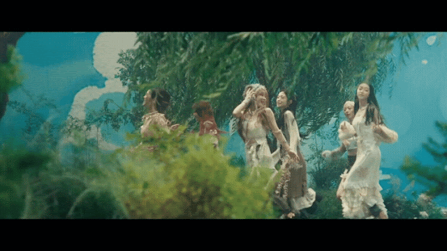 Oh My Girl Gif of Kpop girl group oh my girl in the music video for their song classified. In the gif the members run together through a place covered in trees with a fake sky background