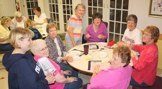 Photo of beaders making bracelets.