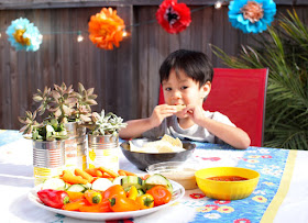 boy eating food at a tie-dye summer grill out party