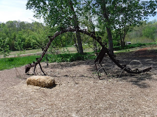 a metal frame of a stegosaurus in the childrens garden in Lauritzen gardens
