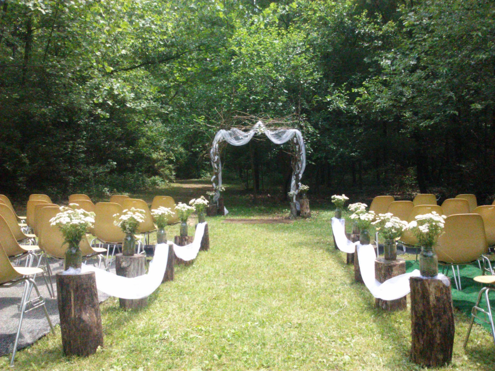 Rustic Outdoor Wedding with logs and twig arbor by Handcrafted 
