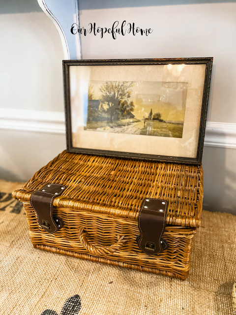 vintage painting on vintage lidded picnic basket with leather straps