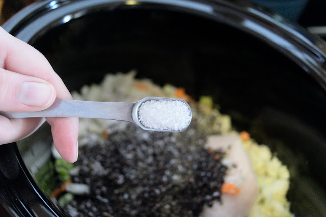 Salt being added to the crock pot.