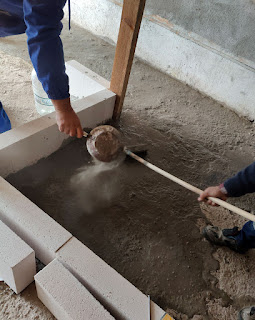 A scattering of cement dust onto the water