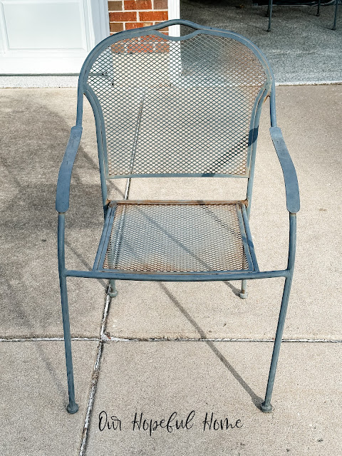 rusted metal patio chair on driveawy