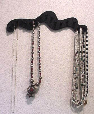 black wall rack for 16 necklaces, squiggle-shaped