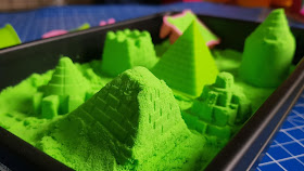 National Geographic Ultimate green Play Sand in plastic sandbox tray with castles and pyramid at front