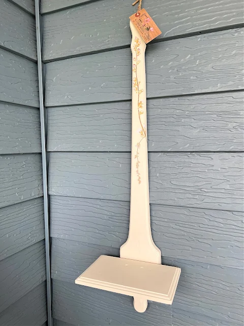 Photo of a wooden candle sconce shelf.