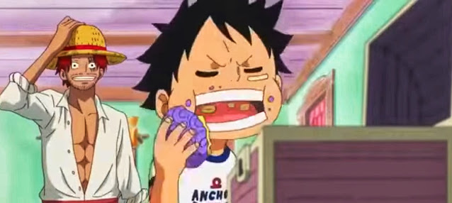 In this angry state, Luffy immediately ate a blue fruit in a box next to him. It turned out that the fruit was Shanks' gomu gomu no mi devil fruit which was placed right next to Luffy.