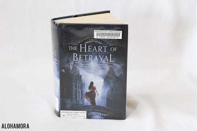 The Heart of Betrayal by Mary E. Pearson is book two in the Remnant Chronicles trilogy.  The second book in this series is a fun addition, with Lia living in enemy territory, Venda.  She is thought to have "The Gift" and the people of Venda quickly connect with Lia. book series, fun reads, teen, high school, adults, clean read, 8th, 9th, 10th, 11th, 12th.  Alohamora Open a Book alohamoraopenabook http://alohamoraopenabook.blogspot.com 