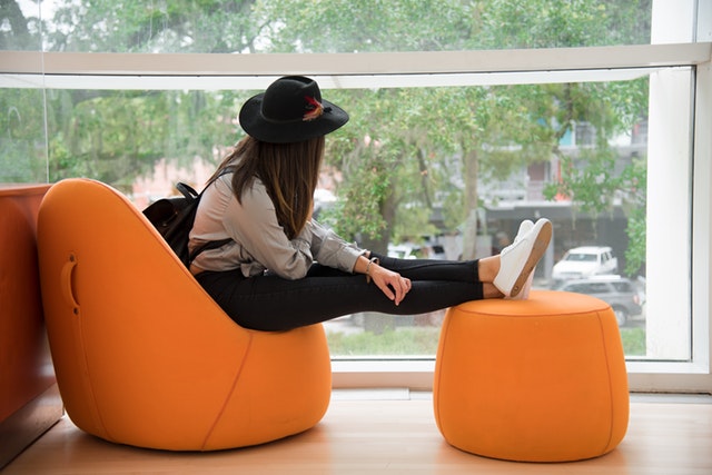 https://www.pexels.com/photo/woman-sitting-on-orange-chair-982049/