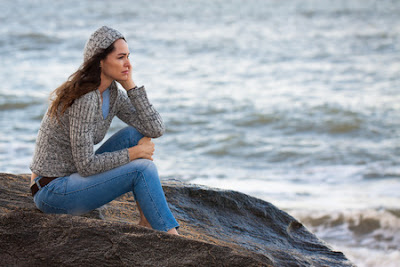 Woman thinking by the ocean