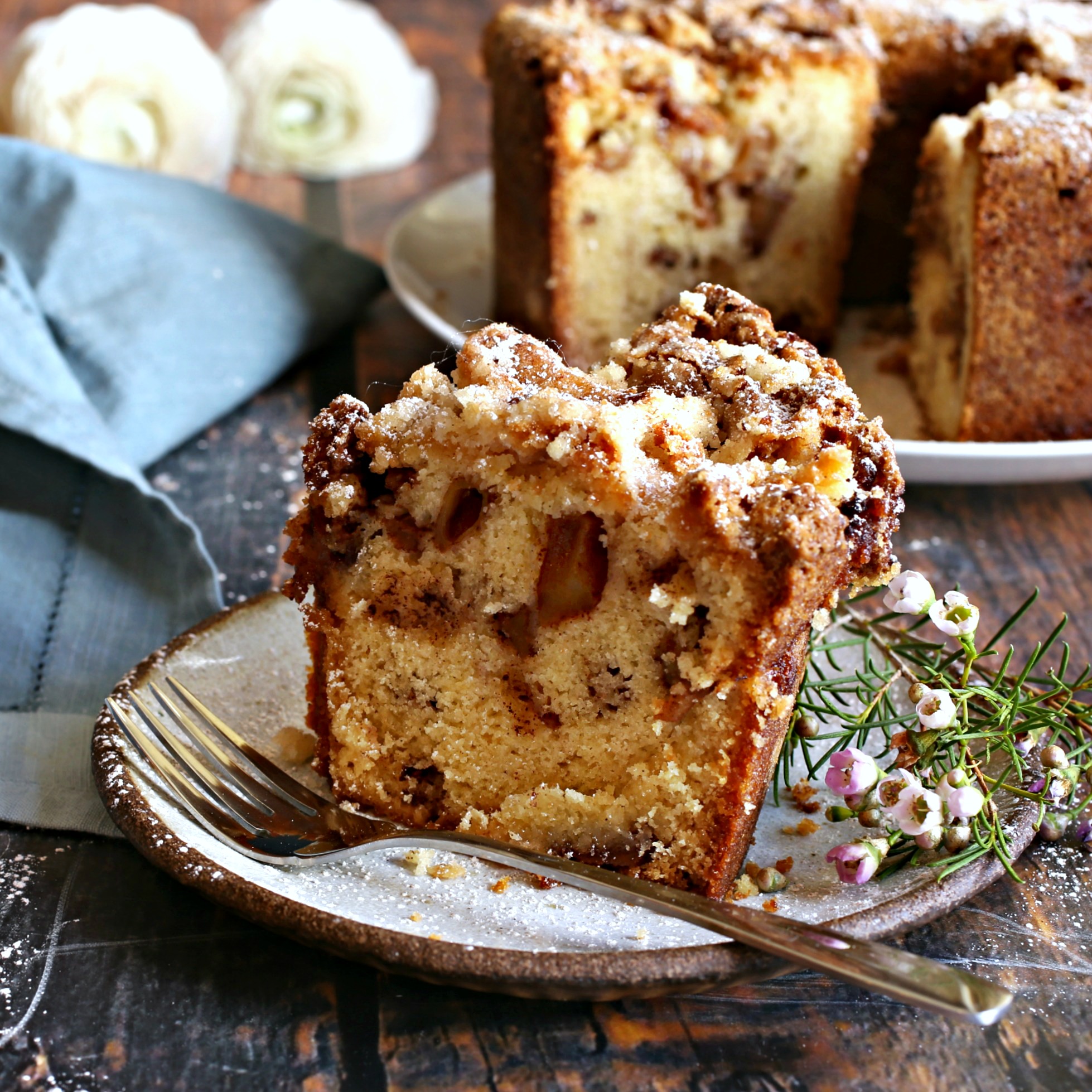 Recipe for a tall cake, bursting with apples, and topped with a brown sugar crust.