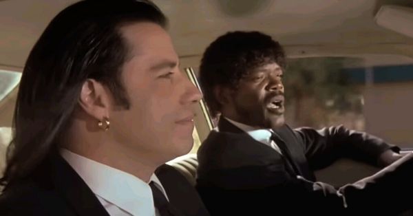 A film still of "Royale with Cheese" scene from Pulp Fiction