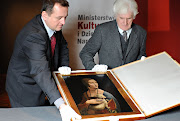 . and Janusz Walek open a box containing the Leonardo da Vinci painting .